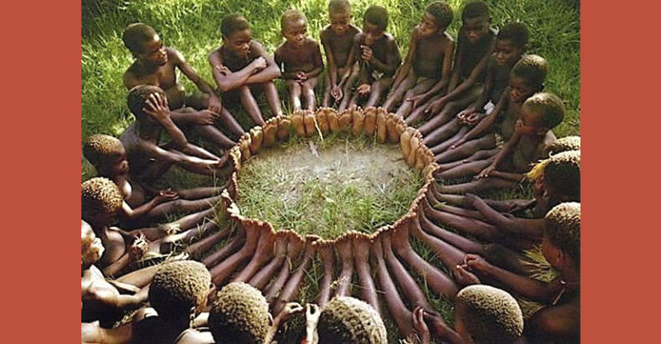 group of children sit in a circle with their feets joined